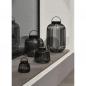 Preview: blomus LITO Black XS Akkuleuchte eingeschaltet mit warmem Licht und dekorativem Schattenspiel